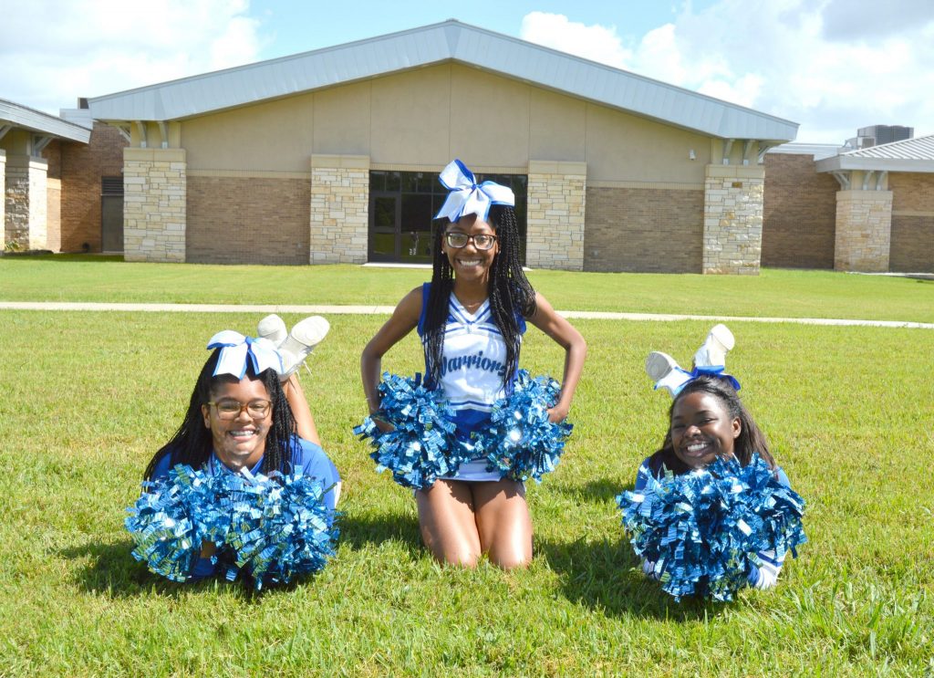 3 cheerleaders on the ground